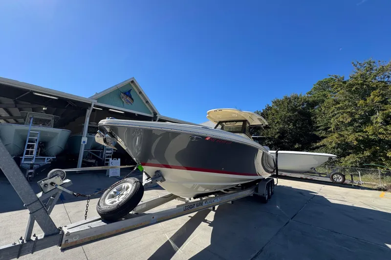  Yacht Photos Pics 2019 Chris-Craft Catalina 30 boat on trailer under clear blue sky.