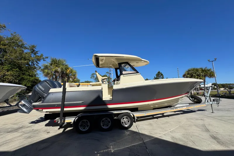  Yacht Photos Pics 2019 Chris-Craft Catalina 30 boat on trailer under clear blue sky.