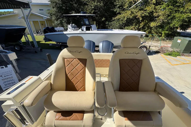  Yacht Photos Pics 2019 Chris-Craft Catalina 30 boat seats with diamond-pattern upholstery in a marina setting.