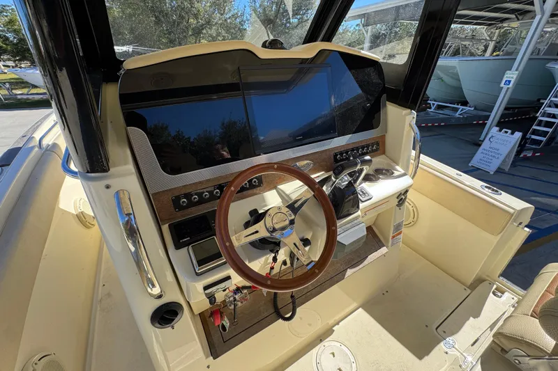  Yacht Photos Pics 2019 Chris-Craft Catalina 30 helm with wooden steering wheel and modern controls.