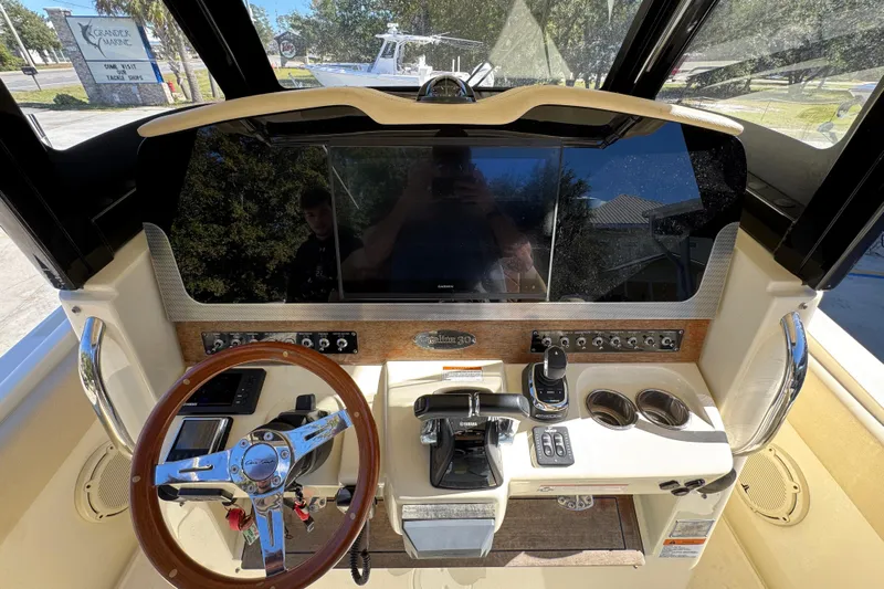  Yacht Photos Pics 2019 Chris-Craft Catalina 30 helm with steering wheel, controls, and display screen.