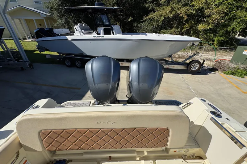  Yacht Photos Pics 2019 Chris-Craft Catalina 30 with dual engines, parked near a Fountain boat on a trailer.