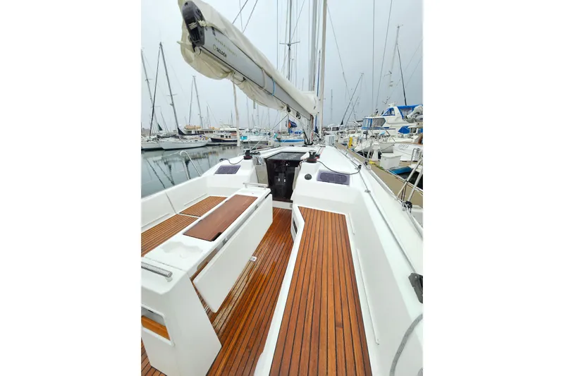 Cutting Edge Yacht Photos Pics 2023 Beneteau Oceanis 34.1 sailboat with teak deck, docked in a marina.