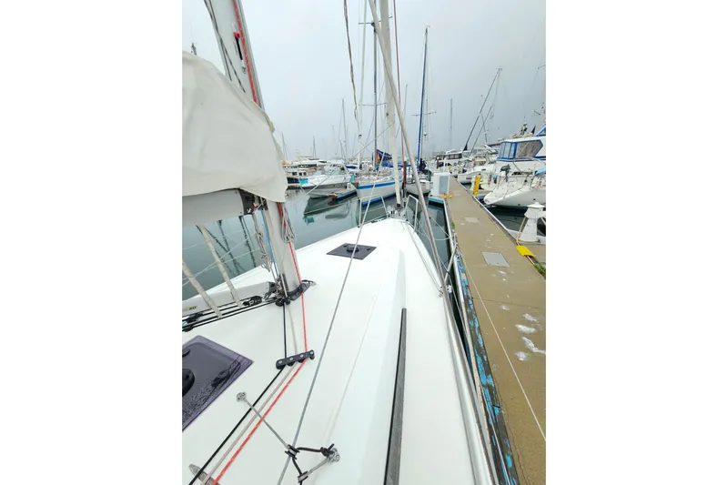 Cutting Edge Yacht Photos Pics 2023 Beneteau Oceanis 34.1 sailboat docked in a marina, showcasing sleek design.