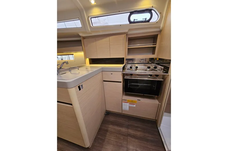 Cutting Edge Yacht Photos Pics 2023 Beneteau Oceanis 34.1 yacht kitchen with modern appliances and sleek cabinetry.