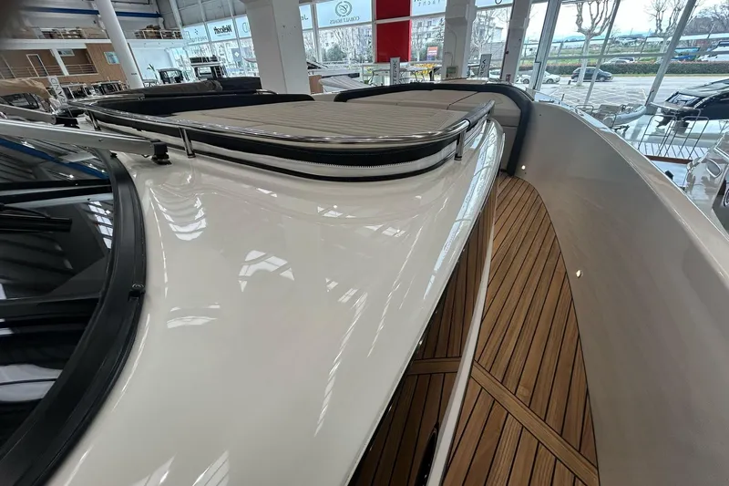  Yacht Photos Pics 2024 Cranchi A46 Luxury Tender with sleek design and wooden deck in showroom.