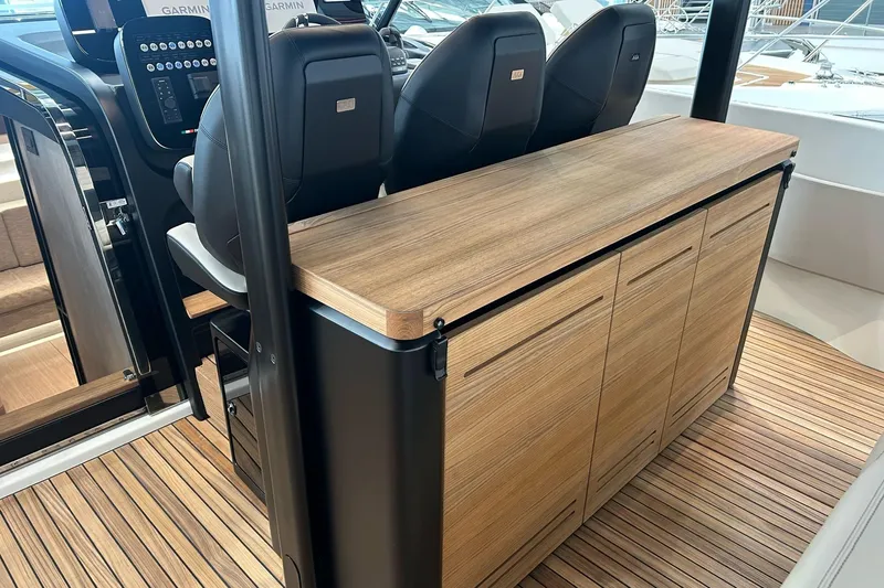  Yacht Photos Pics 2024 Cranchi A46 Luxury Tender interior with sleek wooden cabinetry and modern seating.