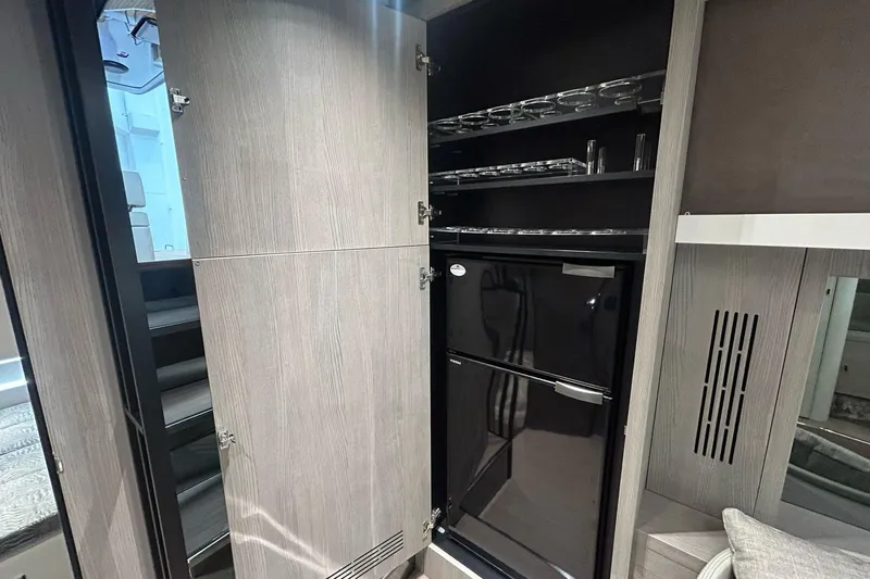  Yacht Photos Pics 2024 Cranchi A46 Luxury Tender interior with sleek cabinetry and modern refrigerator.