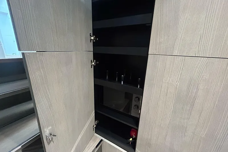  Yacht Photos Pics Open cabinet with shelves inside the 2024 Cranchi A46 Luxury Tender.
