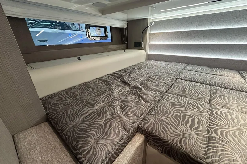  Yacht Photos Pics Luxurious interior cabin of 2024 Cranchi A46 Luxury Tender with patterned bedding.
