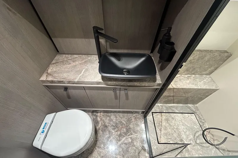  Yacht Photos Pics Luxurious bathroom in 2024 Cranchi A46 Luxury Tender with modern fixtures and marble surfaces.