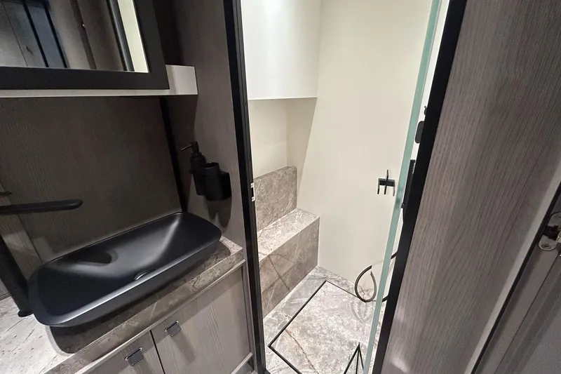  Yacht Photos Pics Modern bathroom interior of 2024 Cranchi A46 Luxury Tender with sleek black sink.