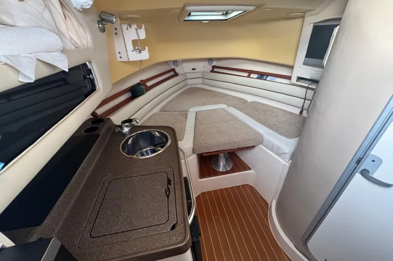  Yacht Photos Pics 2007 Grady-White Marlin 300 cabin interior with kitchenette and seating area.