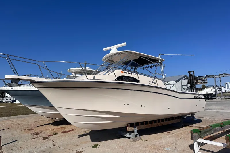  Yacht Photos Pics 2007 Grady-White Marlin 300 boat on dry dock under clear blue sky.