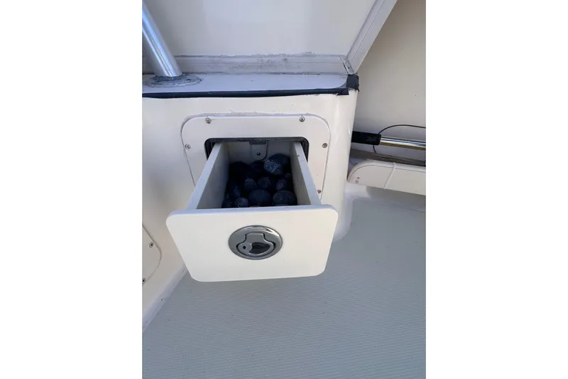  Yacht Photos Pics 2007 Grady-White Marlin 300 boat storage compartment with open drawer containing black balls.