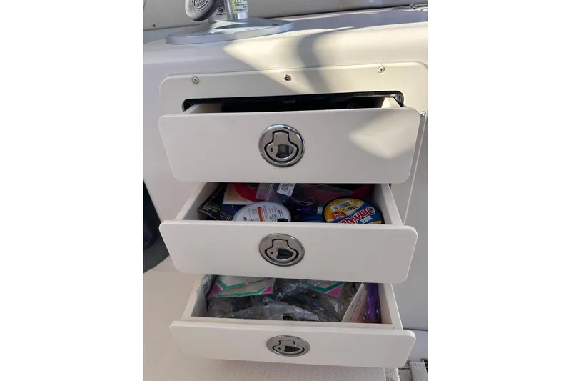  Yacht Photos Pics Open storage drawers on a 2007 Grady-White Marlin 300 boat, containing various items.