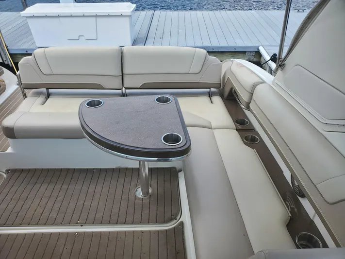  Yacht Photos Pics 2015 Formula 330 Crossover Bowrider interior with cushioned seating and table.