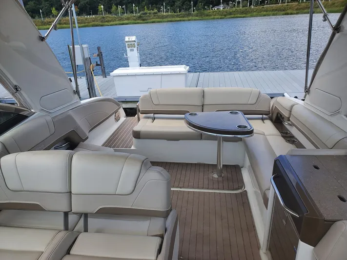  Yacht Photos Pics 2015 Formula 330 Crossover Bowrider interior with seating and table by the water.