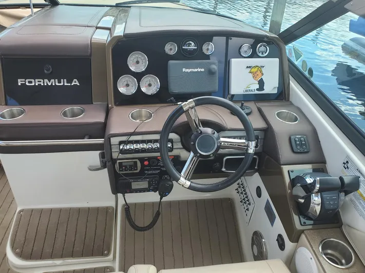  Yacht Photos Pics 2015 Formula 330 Crossover Bowrider dashboard with steering wheel and navigation controls.