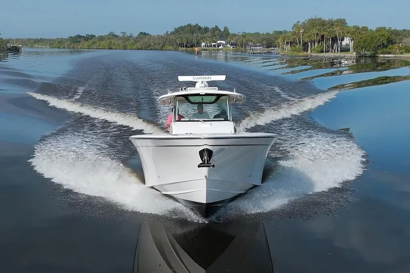 Lucky Penny II Yacht Photos Pics 2018 Grady-White Canyon 376 boat cruising on a calm river, creating a wake.