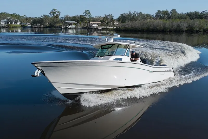 Lucky Penny II Yacht Photos Pics 2018 Grady-White Canyon 376 boat cruising on a calm river.