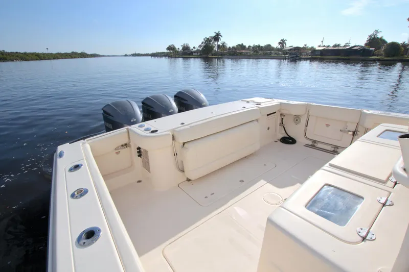 Lucky Penny II Yacht Photos Pics 2018 Grady-White Canyon 376 boat on calm water, featuring spacious deck and triple engines.
