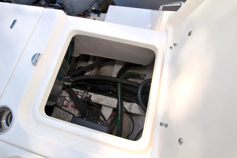 Lucky Penny II Yacht Photos Pics 2018 Grady-White Canyon 376 boat compartment with visible wiring and hoses.