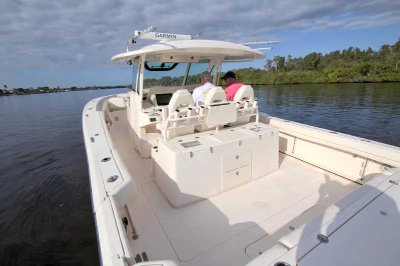 Lucky Penny II Yacht Photos Pics 2018 Grady-White Canyon 376 boat on calm water, featuring spacious deck and modern design.