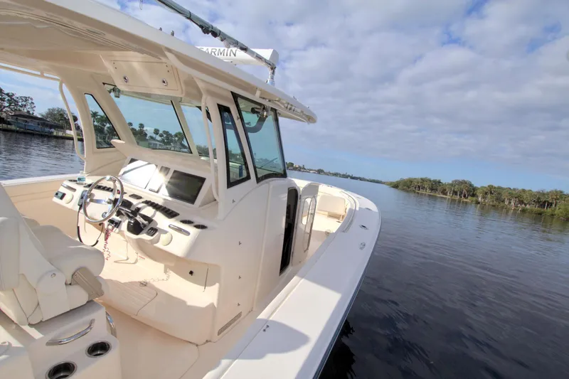 Lucky Penny II Yacht Photos Pics 2018 Grady-White Canyon 376 boat on calm water under a cloudy sky.