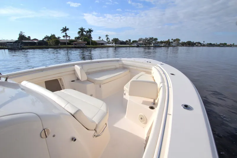 Lucky Penny II Yacht Photos Pics 2018 Grady-White Canyon 376 boat on calm water, featuring spacious seating and clear skies.