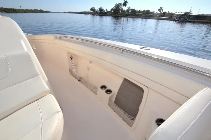 Lucky Penny II Yacht Photos Pics 2018 Grady-White Canyon 376 boat interior, featuring seating and storage, on a calm waterway.