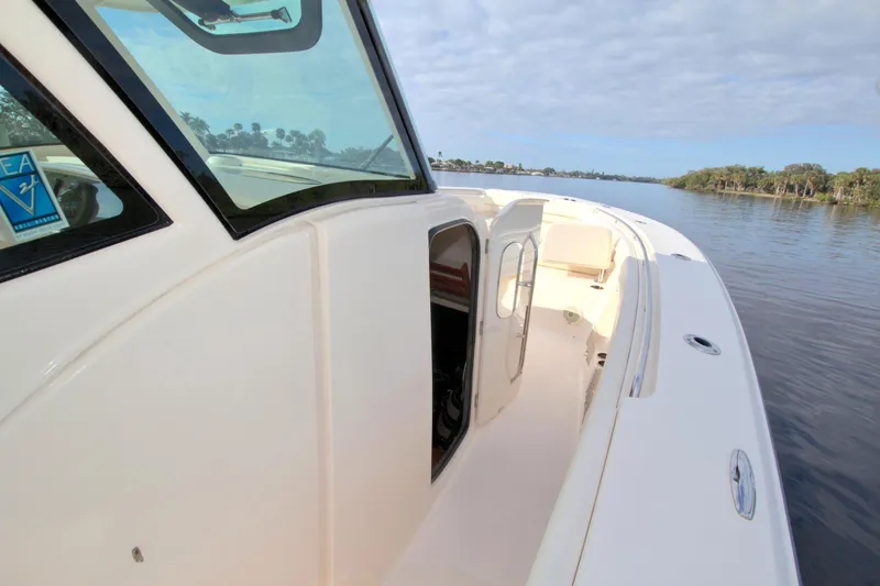 Lucky Penny II Yacht Photos Pics 2018 Grady-White Canyon 376 boat on calm water, showcasing sleek design and spacious deck.