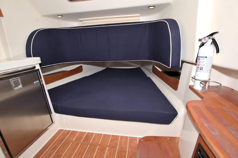 Lucky Penny II Yacht Photos Pics 2018 Grady-White Canyon 376 cabin interior with blue cushions and wood accents.