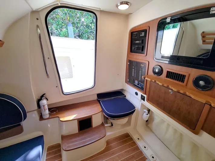 Lucky Penny II Yacht Photos Pics 2018 Grady-White Canyon 376 cabin interior with seating, control panel, and window.
