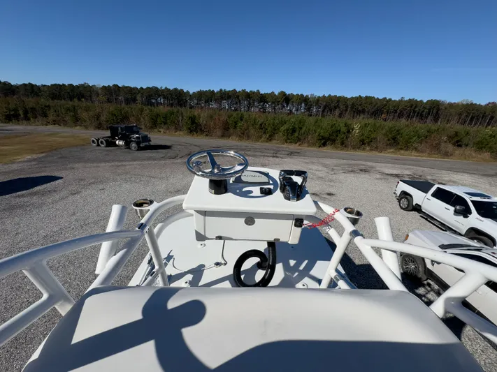 Parker 2801 With Tower And Trailer! Yacht Photos Pics Parker 2801 boat 2022, helm station with steering wheel, surrounded by vehicles.