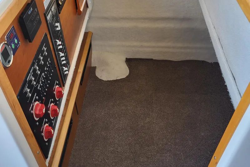 Tranquila Yacht Photos Pics 2023 Cutwater C-288 Coupe interior with control panels and carpeted flooring.