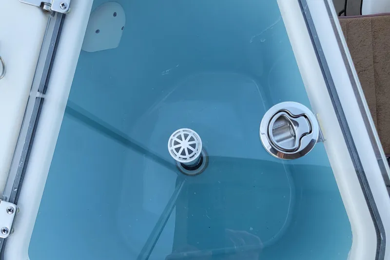 Tranquila Yacht Photos Pics Livewell interior of 2023 Cutwater C-288 Coupe boat, featuring drain and latch.