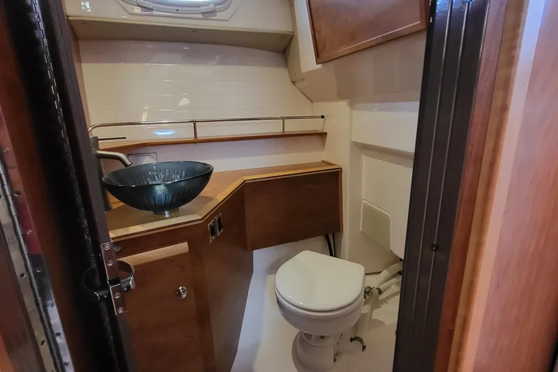 Tranquila Yacht Photos Pics 2023 Cutwater C-288 Coupe bathroom with modern sink and compact toilet.