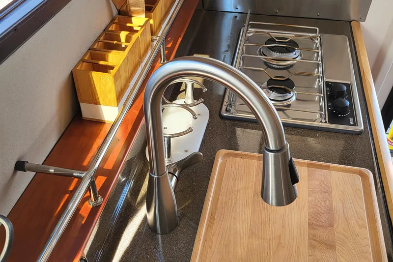 Tranquila Yacht Photos Pics Modern kitchen area in 2023 Cutwater C-288 Coupe with stainless steel faucet and stove.