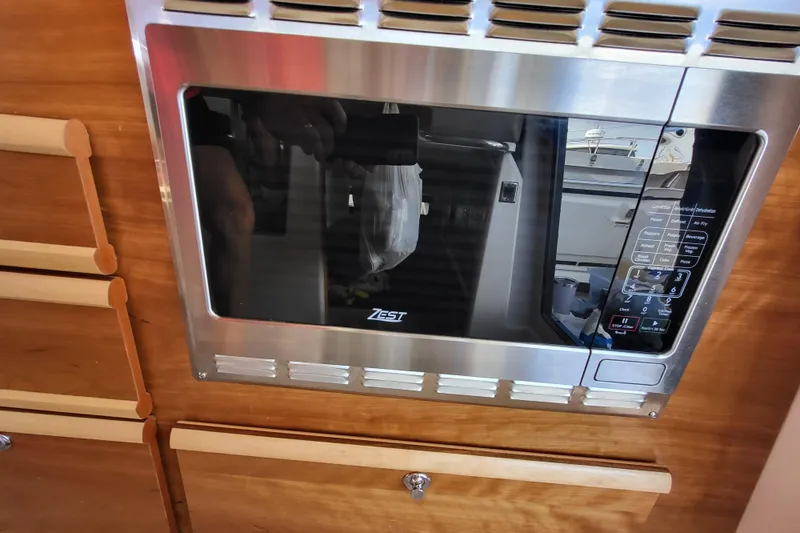 Tranquila Yacht Photos Pics Built-in microwave in 2023 Cutwater C-288 Coupe boat kitchen.
