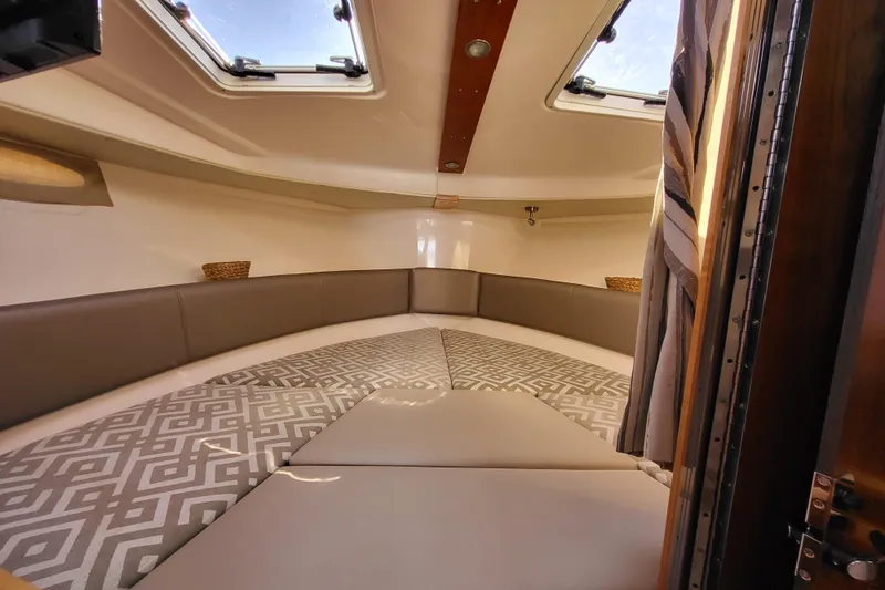 Tranquila Yacht Photos Pics 2023 Cutwater C-288 Coupe interior cabin with skylights and patterned cushions.