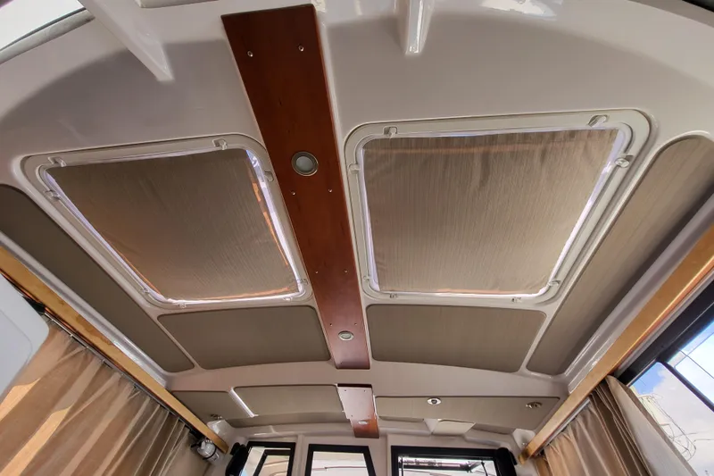 Tranquila Yacht Photos Pics 2023 Cutwater C-288 Coupe interior ceiling with skylights and wood accents.