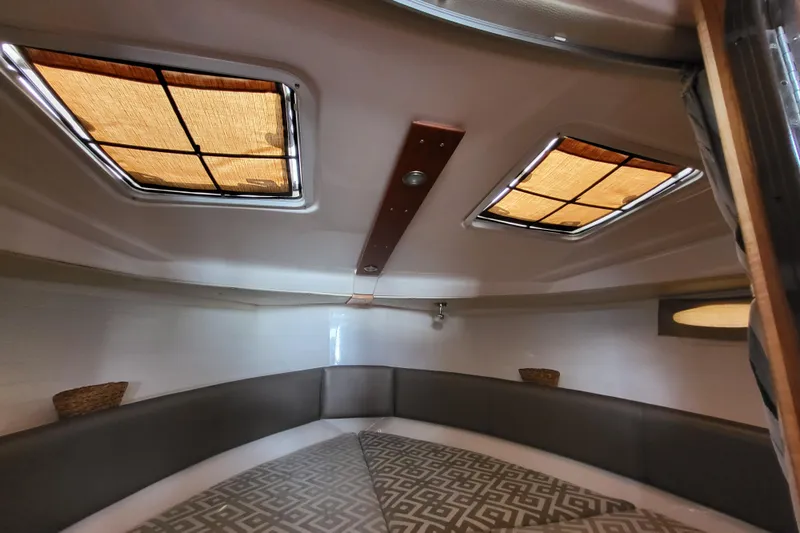 Tranquila Yacht Photos Pics Interior cabin of 2023 Cutwater C-288 Coupe with skylights and cushioned seating.
