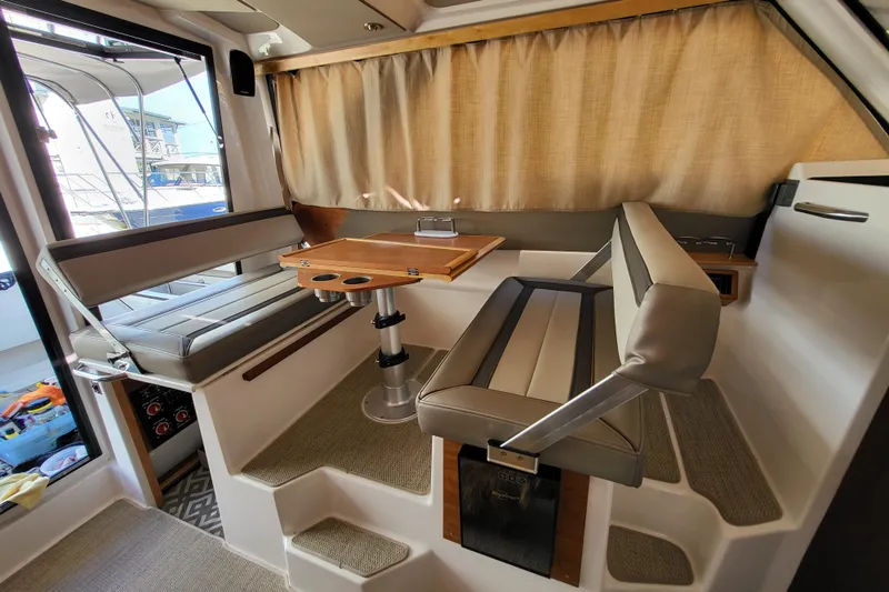 Tranquila Yacht Photos Pics 2023 Cutwater C-288 Coupe interior with seating and table, featuring modern design and comfort.