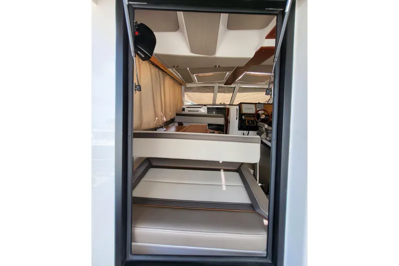 Tranquila Yacht Photos Pics Interior view of 2023 Cutwater C-288 Coupe, showcasing modern seating and helm area.