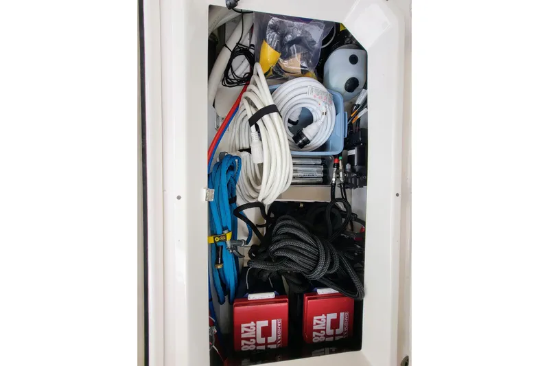 Tranquila Yacht Photos Pics Storage compartment in 2023 Cutwater C-288 Coupe, organized with ropes and equipment.