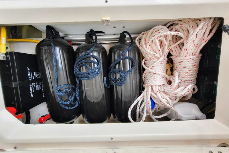 Tranquila Yacht Photos Pics Storage compartment in 2023 Cutwater C-288 Coupe with fenders, ropes, and battery.