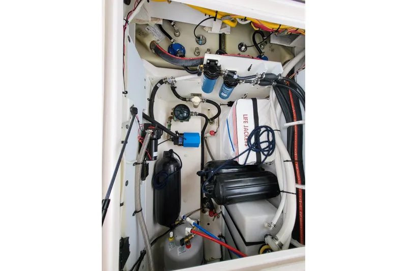 Tranquila Yacht Photos Pics 2023 Cutwater C-288 Coupe engine compartment with life jackets and mechanical components.