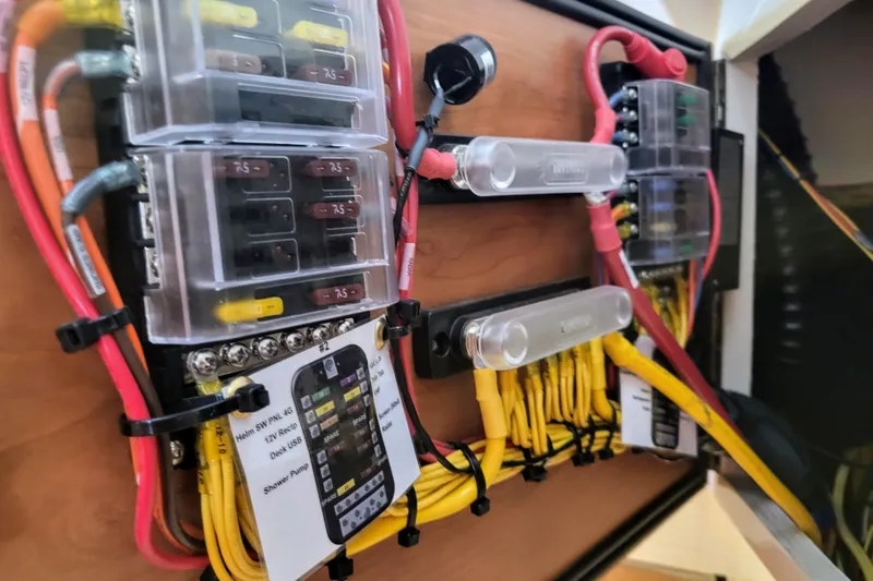 Tranquila Yacht Photos Pics Electrical panel of 2023 Cutwater C-288 Coupe with organized wiring and labeled fuses.