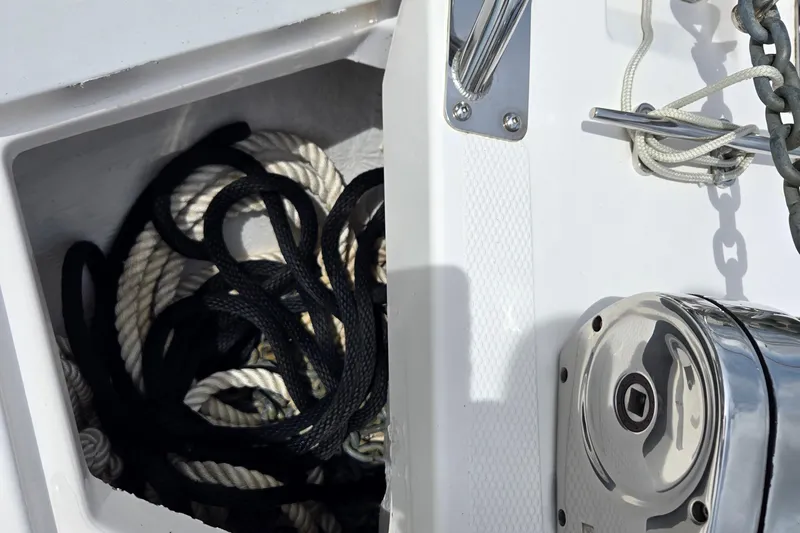 Tranquila Yacht Photos Pics Rope storage compartment on 2023 Cutwater C-288 Coupe boat deck.